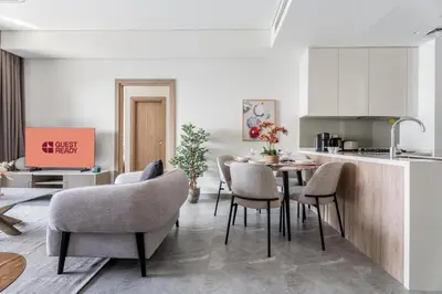 a kitchen and dining room with a table and chairs at GuestReady - 2BR l Stunning Canal View in Dubai