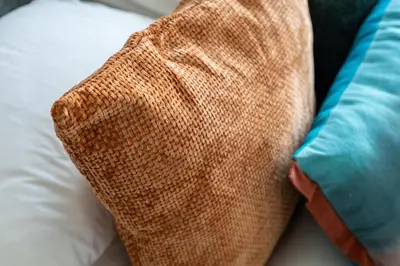 a close up of two pillows on a bed at GuestReady - 2BR l Stunning Canal View in Dubai