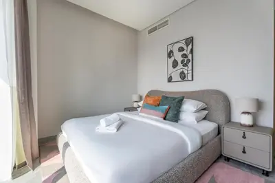 a bedroom with a white bed and a window at GuestReady - 2BR l Stunning Canal View in Dubai