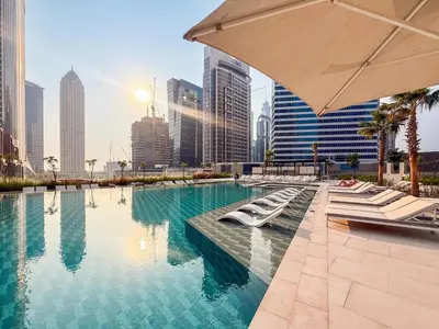 a swimming pool in a city with tall buildings at GuestReady - 2BR l Stunning Canal View in Dubai