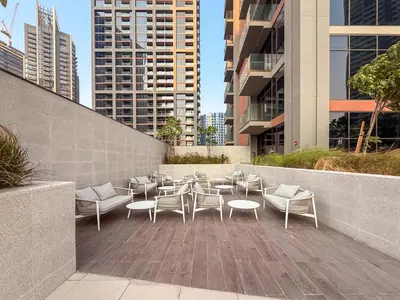 a patio with chairs and tables and buildings at GuestReady - 2BR l Stunning Canal View in Dubai