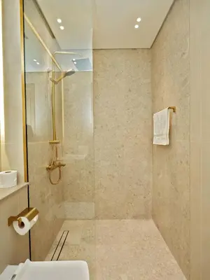 a bathroom with a shower with a glass door at Bright Apartment in JVC with Pool in Dubai