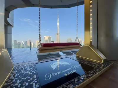 a room with a large window with a view of the city at Paramount Midtown Luxury 2BR Sleeps 7 Near Business Bay Metro and Dubai Mall in Dubai