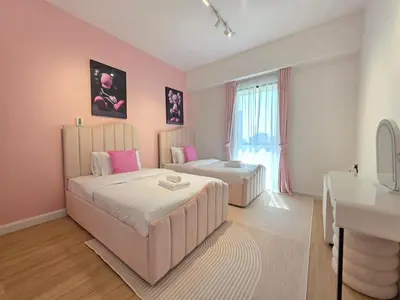 a pink bedroom with two beds and a sink at Spacious 2BR Apartment Rimal 1 JBR EB in Dubai