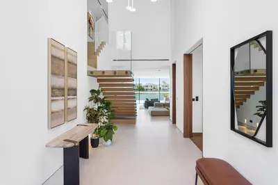 a hallway of a house with a bench and stairs at Premium 4 BR Villa in Palm Jumeirah with Private Pool in Dubai