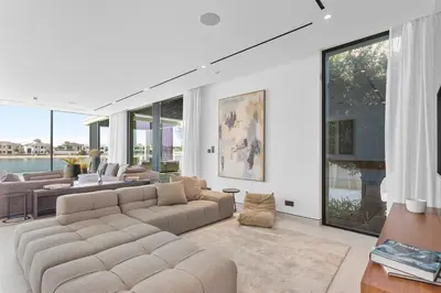 a living room with a couch and a large window at Premium 4 BR Villa in Palm Jumeirah with Private Pool in Dubai