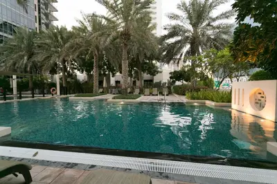 a swimming pool in a building with palm trees at La Dolce Vita in Dubai