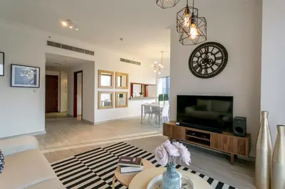 a living room with a flat screen tv on a wall at La Dolce Vita in Dubai