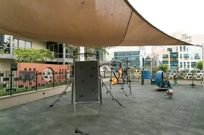 an outdoor playground with a play equipment in a city at La Dolce Vita in Dubai