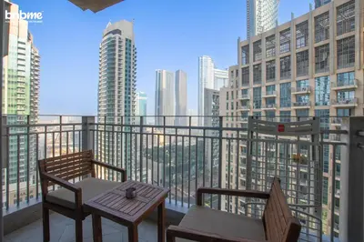 a balcony with two chairs and a table at bnbmehomes - Stand Point Tower A in Dubai