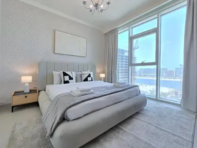 a bedroom with a large bed with a large window at Luxury Sea View Palace Beach Residence by Emaar in Dubai