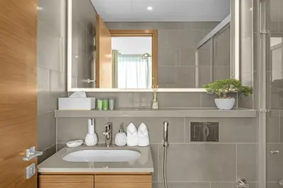 a bathroom with a sink and a mirror at Waves - Modern & Cozy 1BR Apt Close to Down Town Dubai in Dubai