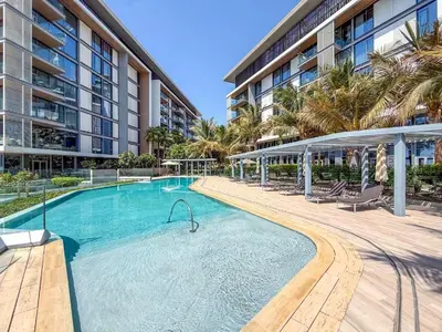 a large swimming pool in front of a building at Bluewaters Residences 1BR Prime Sea and Ain View in Dubai