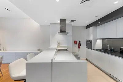 a kitchen with white cabinets and a white counter top at Bluewaters Residences 1BR Prime Sea and Ain View in Dubai