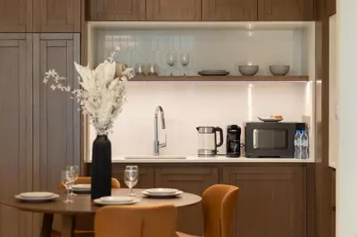 a kitchen with a table with a vase of flowers at Chic 1BR Sea View, Palace Beach Residence in Dubai