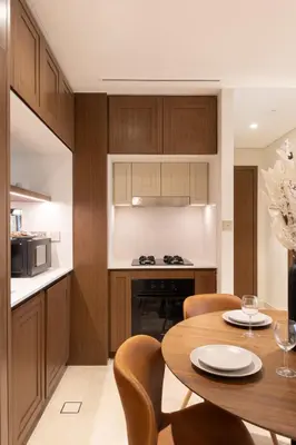 a kitchen and dining room with a table and chairs at Chic 1BR Sea View, Palace Beach Residence in Dubai