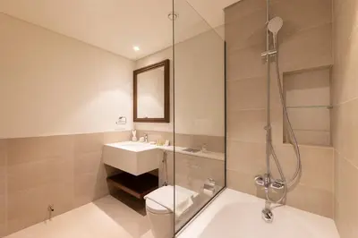 a bathroom with a shower and a toilet and a sink at Chic 1BR Sea View, Palace Beach Residence in Dubai