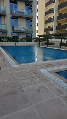 a swimming pool in front of a building at Peace Home in Dubai