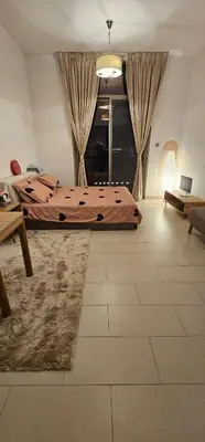 a bedroom with a bed and a large window at Peace Home in Dubai
