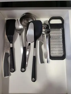 a group of utensils are arranged in a drawer at Bright 2BR Apartment 5-Min Walk to Metro & Mall 1124 in Dubai
