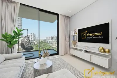 a living room with a tv and a large window at Bright 1BR Apartment in Binghatti Phoenix High-Floor Views in Dubai