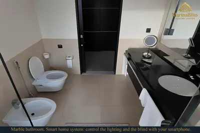a bathroom with a toilet and a sink and a mirror at Deluxe 5 stars Suite - JW Marriott-Marina Mall - Once you see it, you book it! in Dubai