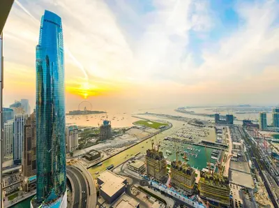 a view of a city with a tall skyscraper at Oceanview Palmview Dubai Eye Ain Marina 2BHK in Dubai