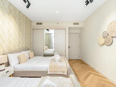 a living room with a bed and a couch at Oceanview Palmview Dubai Eye Ain Marina 2BHK in Dubai
