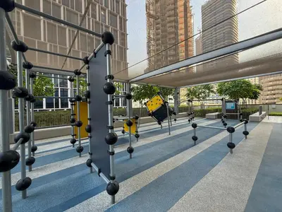 a metal structure with a yellow sign on a building at 18 Vida Dubai Mall Newly Furnished 1 bedroom in Dubai