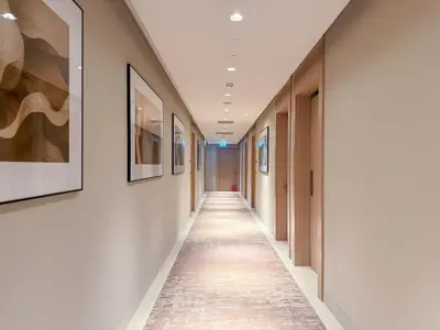 a corridor in a hospital with paintings on the walls at 18 Vida Dubai Mall Newly Furnished 1 bedroom in Dubai