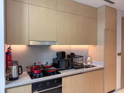 a kitchen with a stove with pots and pans on it at 18 Vida Dubai Mall Newly Furnished 1 bedroom in Dubai