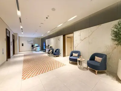 a hallway with blue chairs and a waiting room at 18 Vida Dubai Mall Newly Furnished 1 bedroom in Dubai
