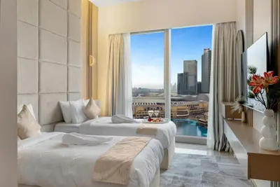 a hotel room with two beds and a large window at Ultra-luxury 2BHK apartment Stunning Burj Khalifa & Fountain view in Dubai