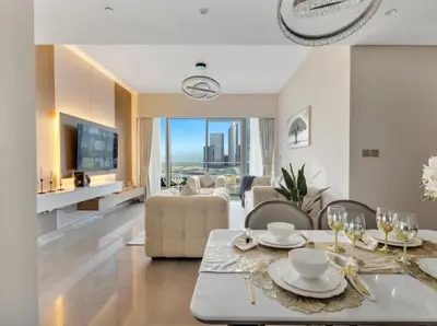 a living room with a table and a couch at Ultra-luxury 2BHK apartment Stunning Burj Khalifa & Fountain view in Dubai