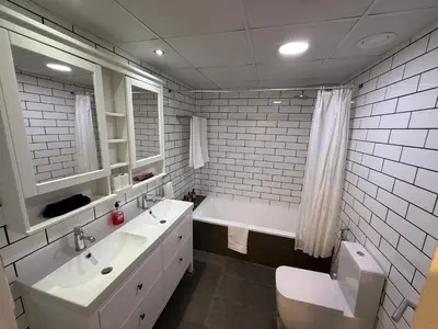 a bathroom with two sinks and a tub and a toilet at Marina View 2BHK, Spacious Apartment in a Prime Location, Quick Access to Tram, Metro & Beach in Dubai