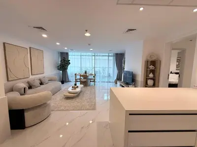 a living room with a couch and a table at Marina View 2BHK, Spacious Apartment in a Prime Location, Quick Access to Tram, Metro & Beach in Dubai