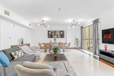 a living room with a couch and a table at VayK - Spacious 3BR in JBR with Beach Access in Dubai
