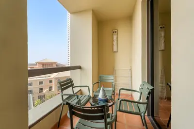 a balcony with a table and chairs on a balcony at VayK - Spacious 3BR in JBR with Beach Access in Dubai