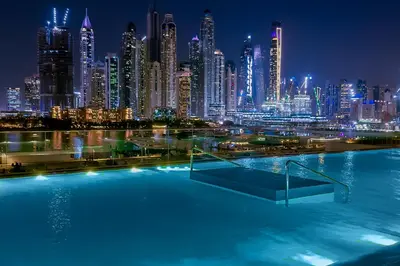 a view of a city skyline at night at Luxury Branded Suite with Direct Private Beach Access & Sea Views in Dubai