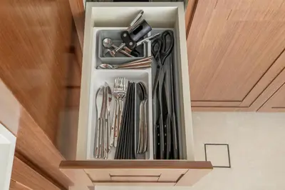 a drawer filled with utensils in a kitchen at Luxury Branded Suite with Direct Private Beach Access & Sea Views in Dubai