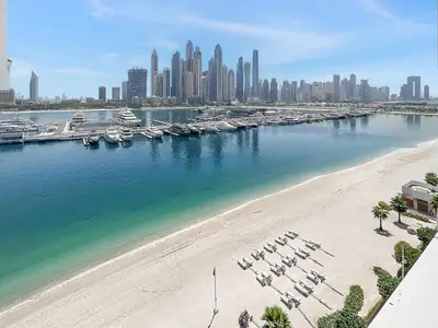 a view of a beach with boats in a harbor at Luxury Branded Suite with Direct Private Beach Access & Sea Views in Dubai
