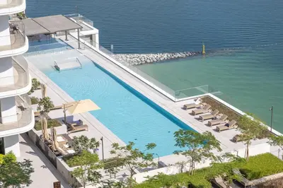 an overhead view of a swimming pool next to the ocean at Luxury Branded Suite with Direct Private Beach Access & Sea Views in Dubai