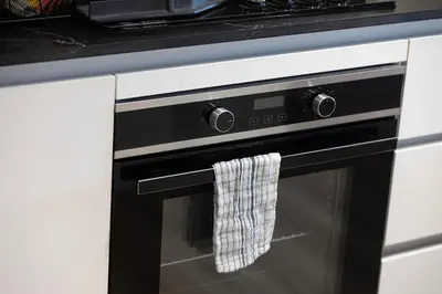 a black oven door with a towel hanging from it at Luxury Studio with Private Jacuzzi in Business Bay in Dubai