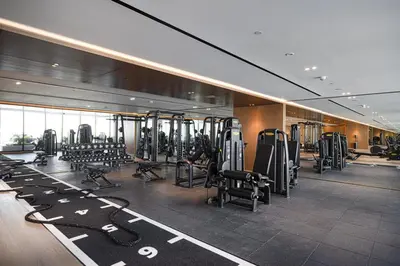 a gym on a cruise ship with rows of tread machines at Luxury Studio with Private Jacuzzi in Business Bay in Dubai