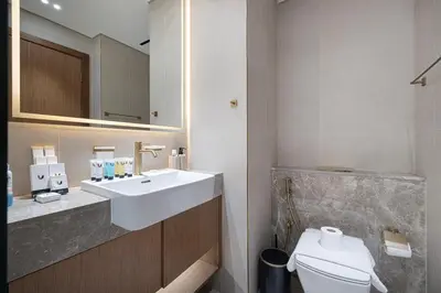 a bathroom with a sink and a toilet at Luxury Studio with Private Jacuzzi in Business Bay in Dubai