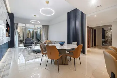 a dining room with a table and chairs at 3BR with Burj Khalifa View - Pool - Gym - Downtown in Dubai