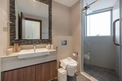 a bathroom with a sink and a toilet and a shower at 3BR with Burj Khalifa View - Pool - Gym - Downtown in Dubai