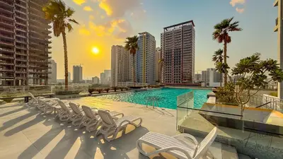 a swimming pool on the roof of a building at Skyline View Stu 20th Floor Regina Tower, JVC in Dubai