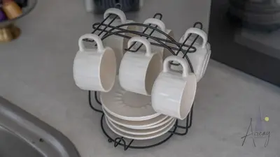 a stack of white plates in a kitchen at Skyline View Stu 20th Floor Regina Tower, JVC in Dubai