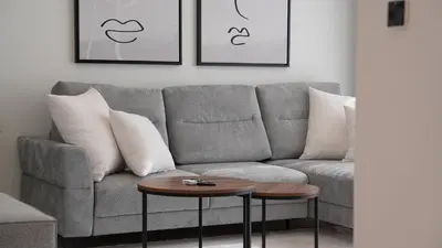 a living room with a couch and a table at Creek Vista Elegance-1BRBurj Khalifa View in Dubai
